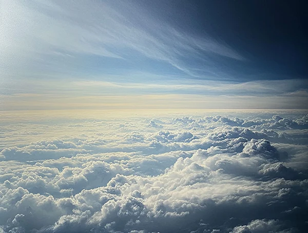 Über die Wolken fliegen Blick von oben auf Wolkendecke